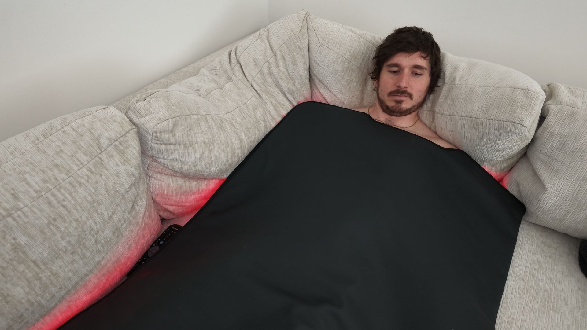 Zero friction red light blanket routine used while relaxing on the sofa