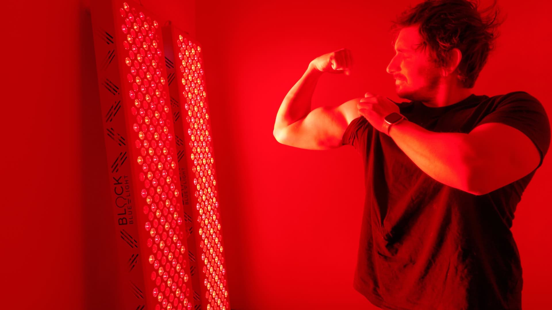 Standing next to high powered BlockBlueLight panels demonstrating athletic recovery