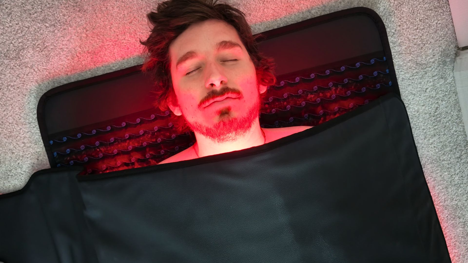 The ultimate recovery sandwich: laying on a heated PEMF mat with a red light blanket draped on top
